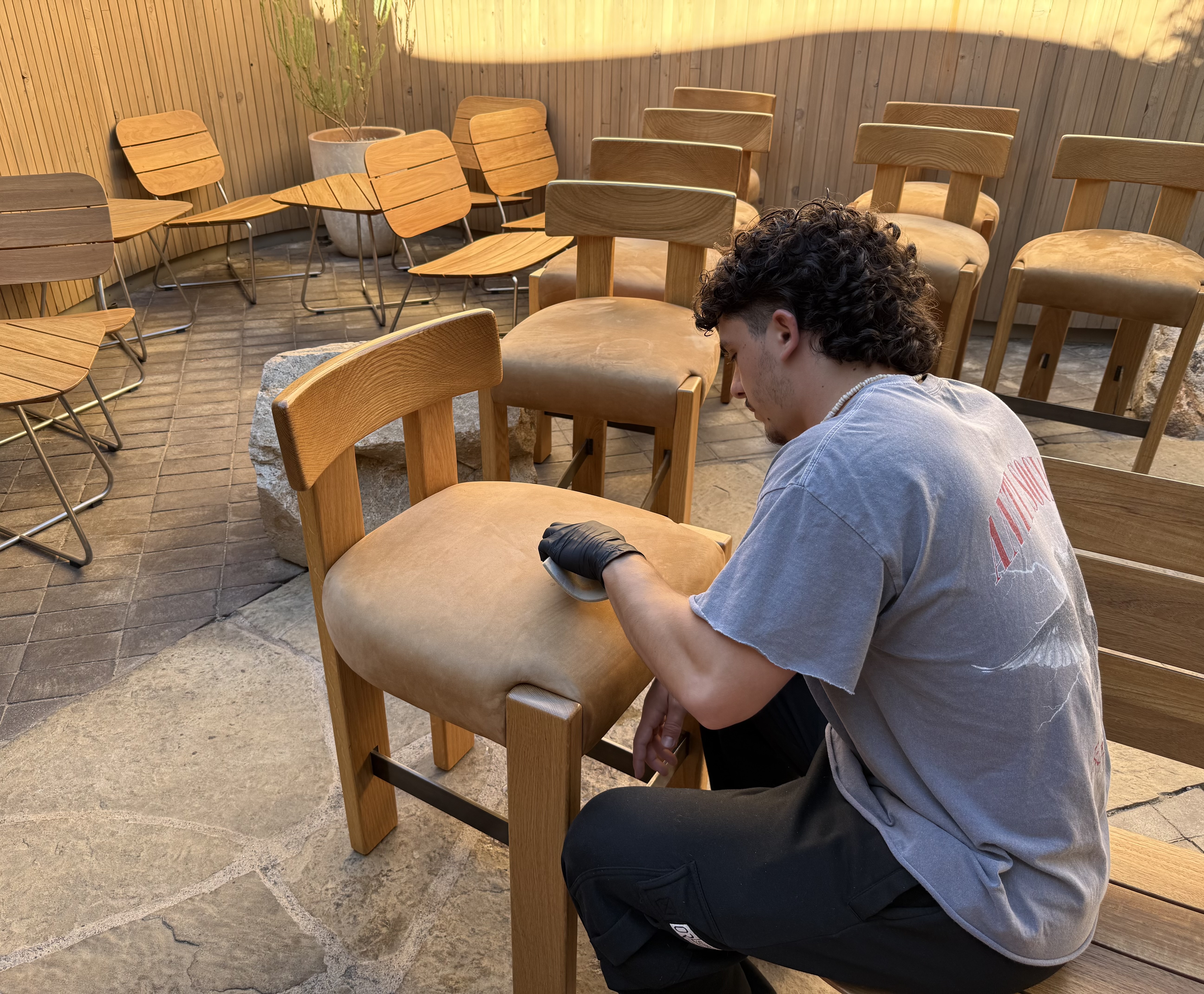 Tristan restoring the finish on leather dining chairs