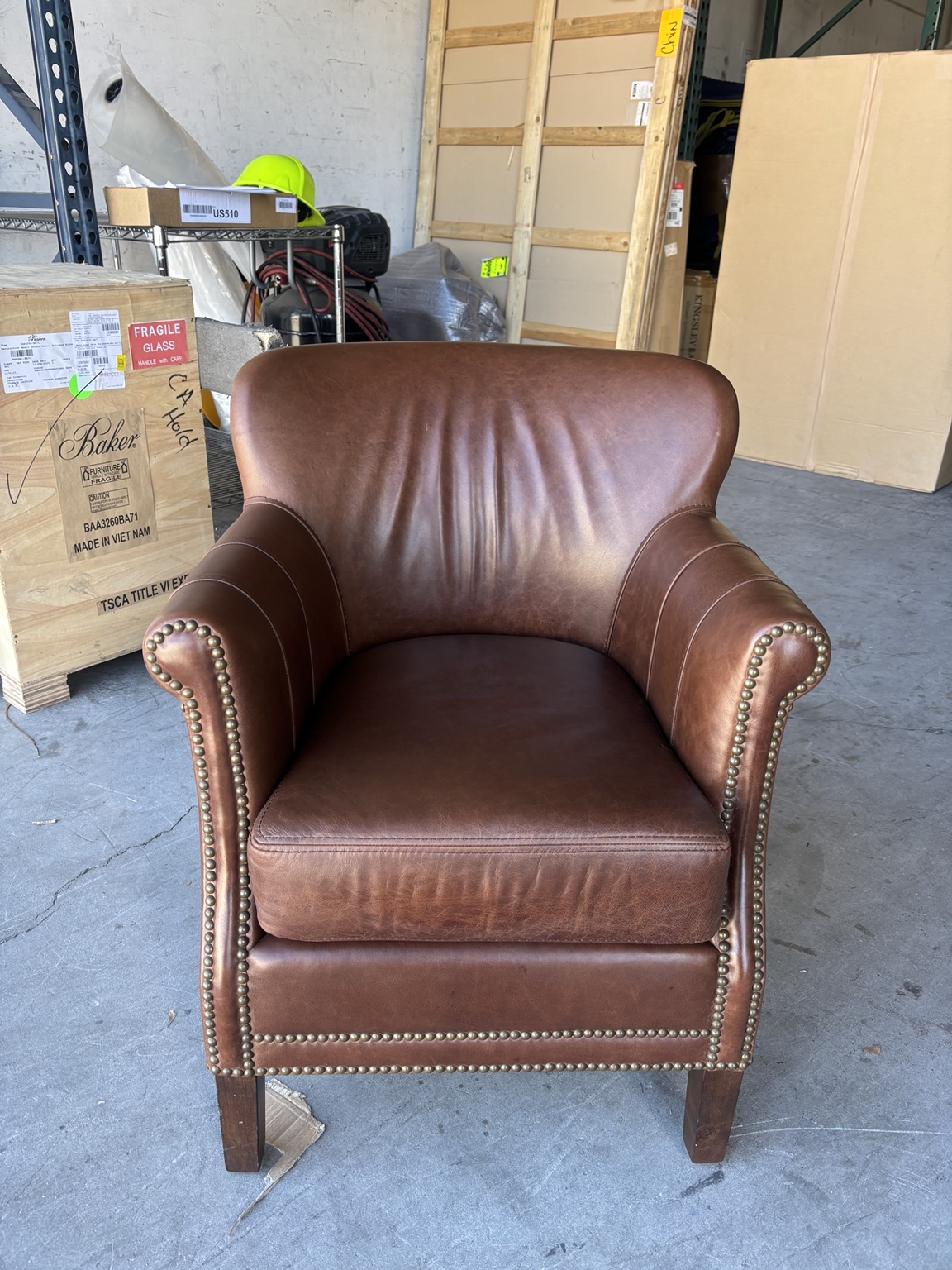 Same leather chair with restored, even brown color after restoration