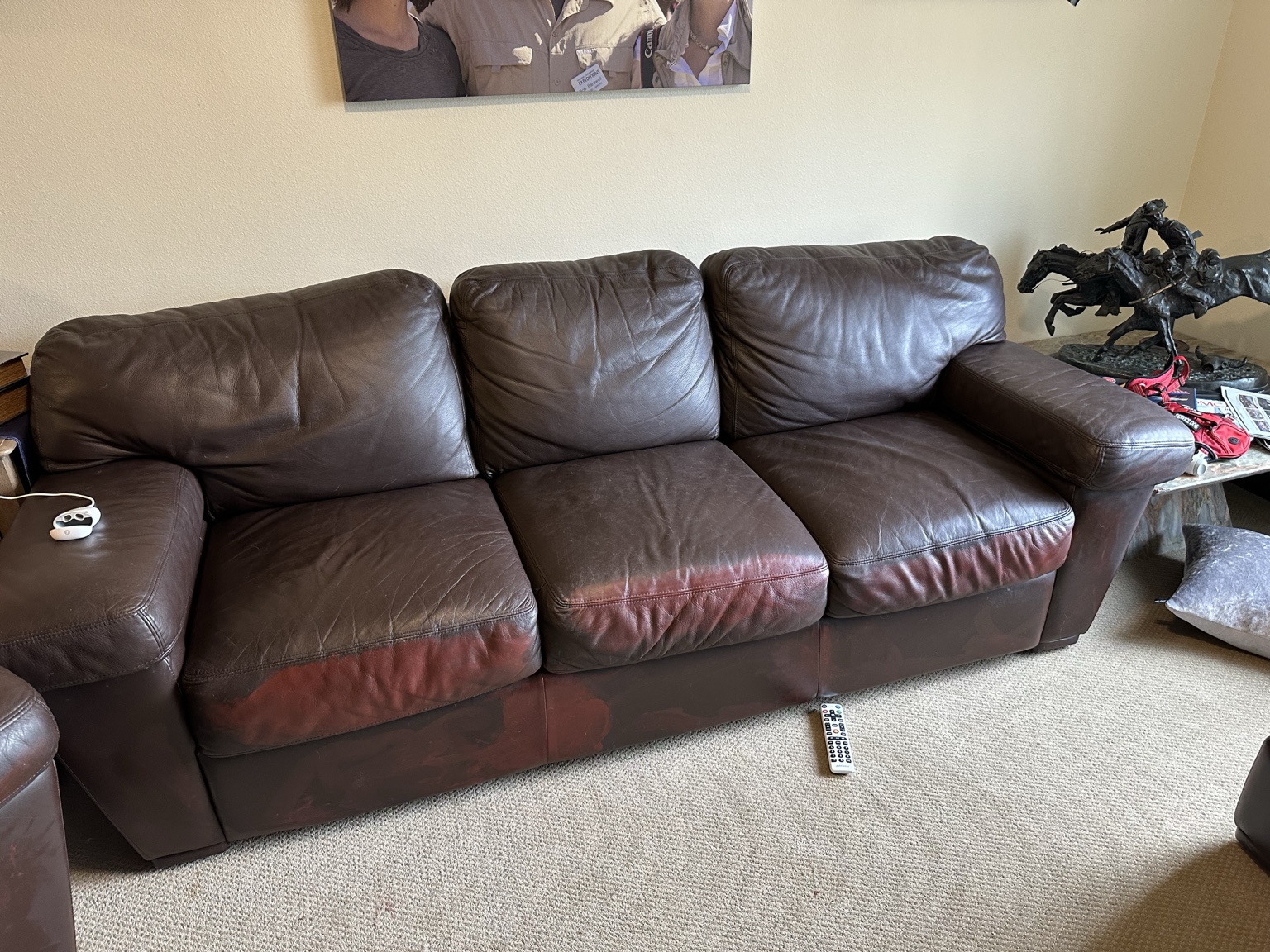 Leather sofa with visible discoloration on the lower cushions